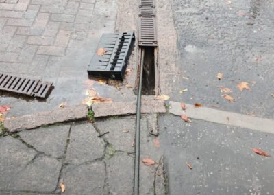 Drainage channel covers removed during commercial drainage cleaning in Maryhill, Glasgow