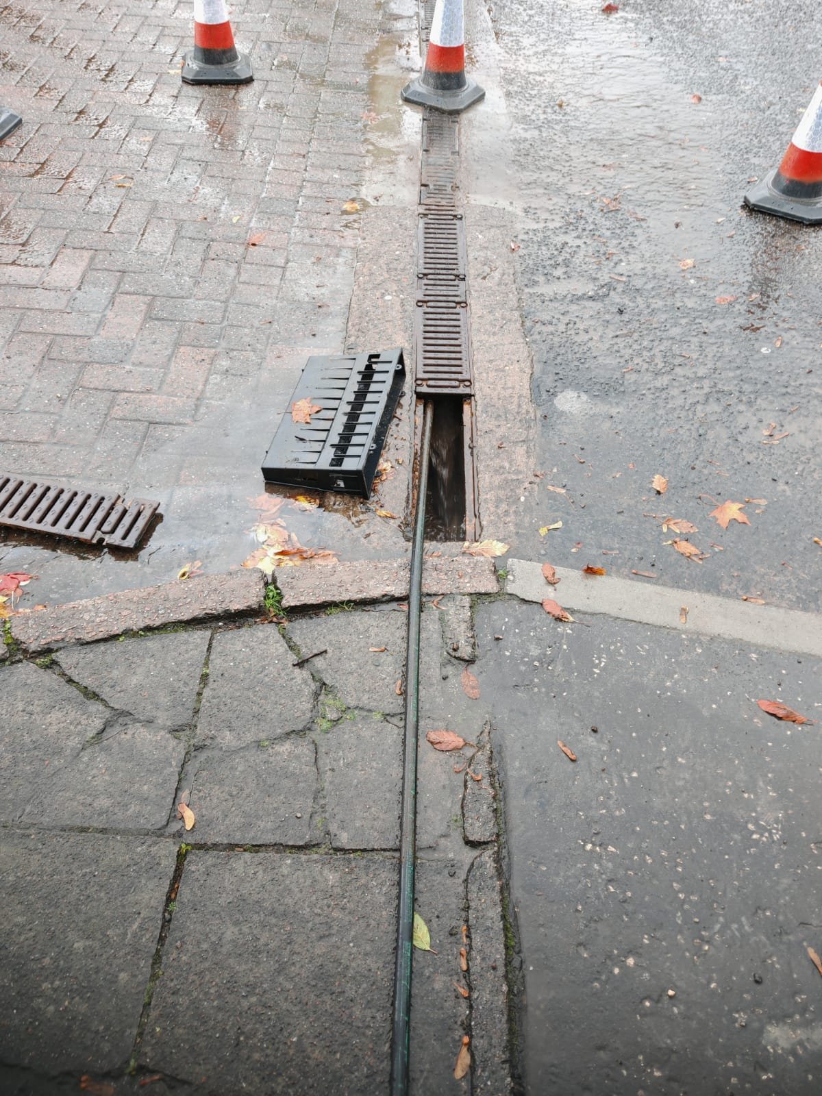 Drainage channel covers removed during commercial drainage cleaning in Maryhill, Glasgow