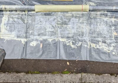 Drain clearance equipment in use at an access chamber in Pollokshields