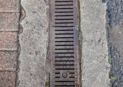 Surface water drainage grate inspected during commercial maintenance in Glasgow